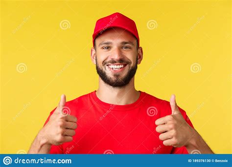 Close-up of Friendly Smiling Delivery Guy in Red Uniform Cap and T-shirt Provide Best Express ...