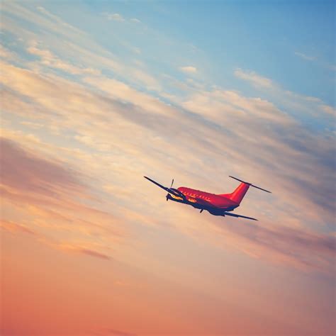 Premium Photo | Airplane taking off at the sunset sky