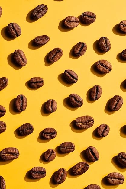 Premium Photo | Roasted coffee beans on yellow background