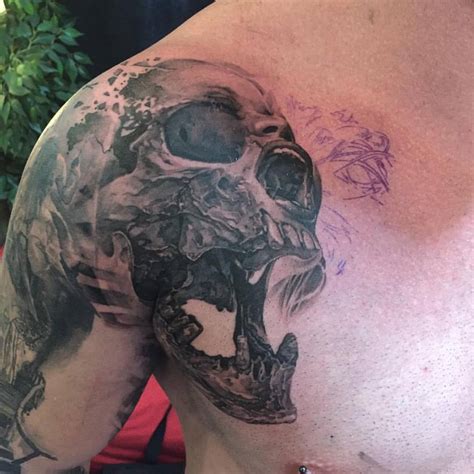 Black Ink Skull Tattoo On Shoulder