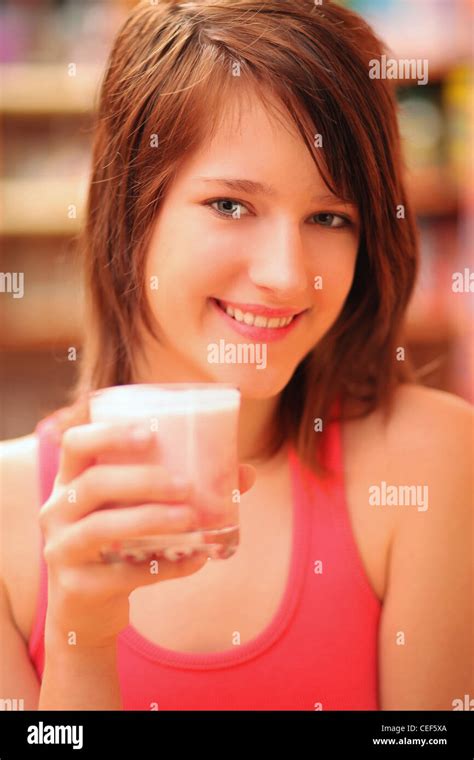 Teenage girl drinking milk shake Stock Photo - Alamy