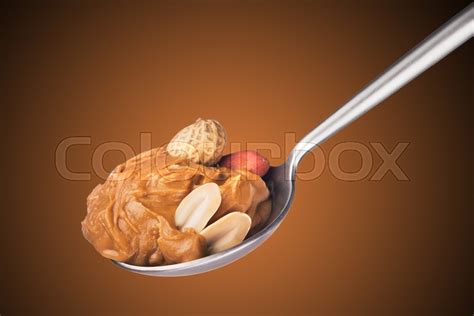 Spoon with peanut butter on a brown ... | Stock image | Colourbox