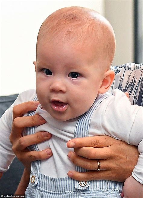 a man holding a baby in his arms