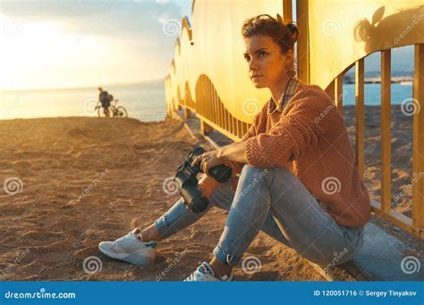 Young Beautiful Hiking Girl Sits on the Beach and Enjoy View of Stock Photo - Image of resting ...