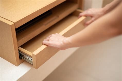 Premium Photo | Woman hand pull open drawer wooden cabinet.