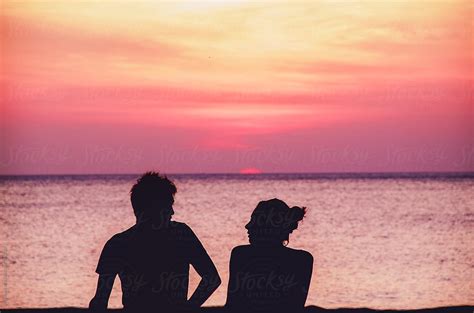 "Silhouette Of A Couple Sitting On The Beach And Talking During The ...