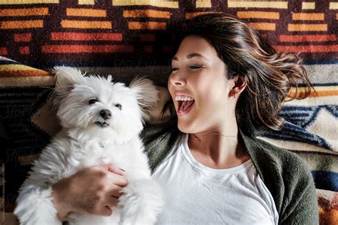 "Beautiful Woman Playing With Her Dog On The Bed" by Stocksy Contributor "Take A Pix Media ...