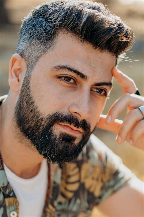 Portrait of a Handsome Man with a Beard Posing with His Hand on His ...