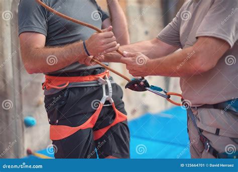 Rock Wall Climber Wearing Safety Harness and Climbing Equipment Indoor ...