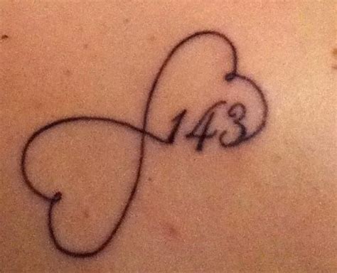 a tattoo on the back of a woman's stomach with an infinite love symbol