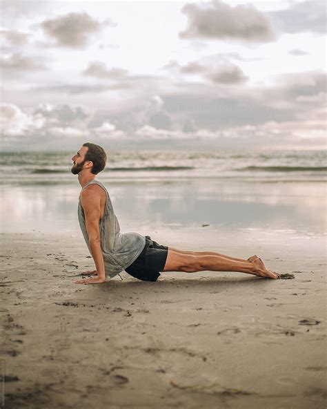 Handsome caucasian man practicing yoga on the beach Stock Photography ...