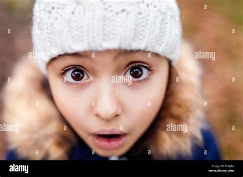 Portrait of little girl with eyes wide open Stock Photo - Alamy