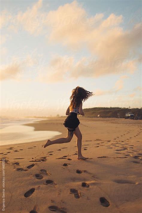 A Girl Running On The Beach Barefoot by Evgeniya Savina