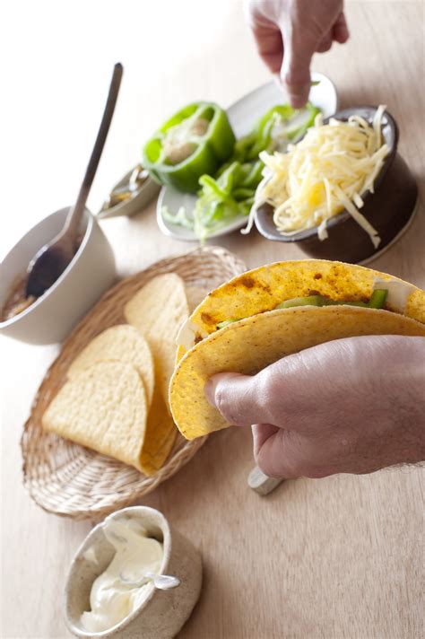 Free Stock Photo 12293 Man filling a taco with sour cream and cheese | freeimageslive