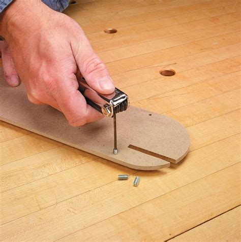 a man is using a drill to fix a piece of wood on top of a wooden floor