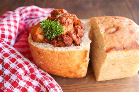 Bunny chow filled with chicken curry. A traditional South African cuisine called a bunny chow ...