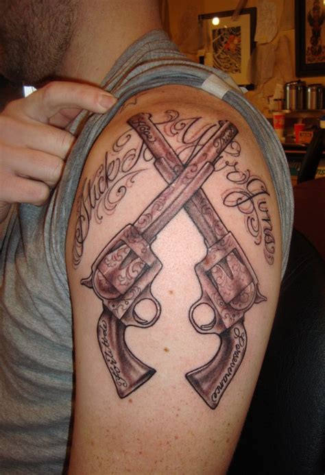 Crossed Pistols Tattoo On upper Arm