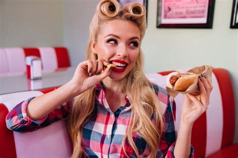 Photo of Charming Joyful Woman Eating Hotdog and French Fries Stock Photo - Image of american ...