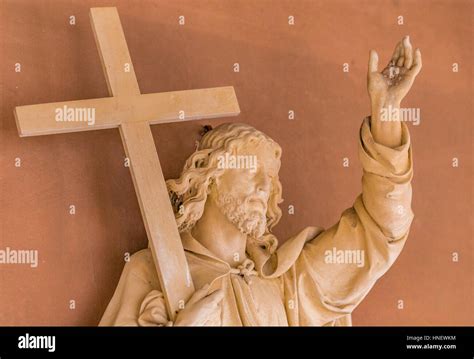 wooden sculpture of Jesus Christ holding the Cross Stock Photo - Alamy