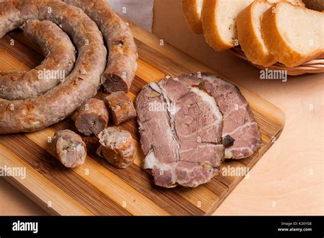 Roasted traditional homemade sausage with spices and herbs and slices ...