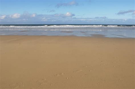 Peaceful, Sandy Beach At Low Tide Photograph by Johngollop - Fine Art America