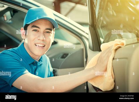 Smiling auto service staff cleaning car door - car detailing and valeting concept Stock Photo ...