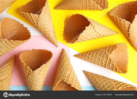 Empty wafer ice cream cones on color background, flat lay Stock Photo by ©NewAfrica 287778228