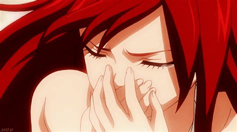 a woman with red hair covers her face while she holds her hands to her mouth