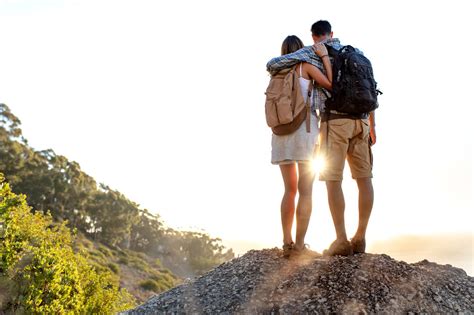 Hiking couple standing on a rock admiring the view Photo (159090) - YouWorkForThem