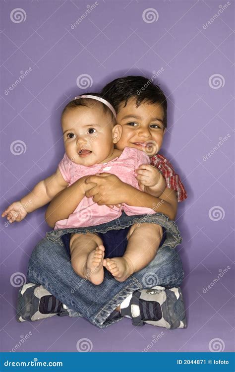 Boy Holding Baby Girl. Stock Image - Image: 2044871