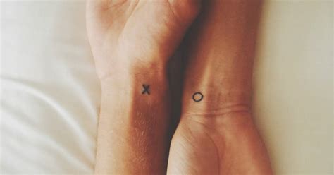 "X" and "O" matching tattoos.