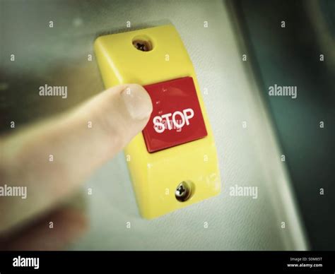 Red stop button with finger about to press it Stock Photo - Alamy