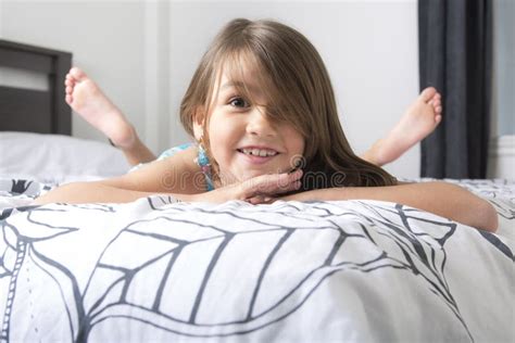 Portrait of Beautiful Little Girl Lying on Bed Stock Photo - Image of ...