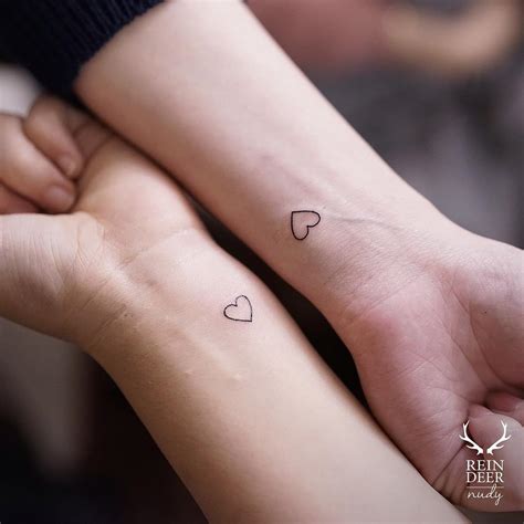 Matching tiny heart tattoos by Nudy tattooer - Tattoogrid.net