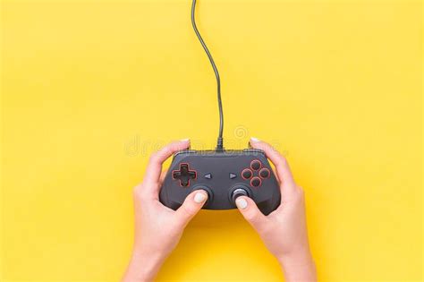 Hands Holding Gamepad. Black Joysticks on Yellow Background. Computer Game Competition. Gaming ...