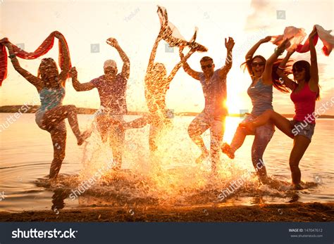 Large Group Of Young People Enjoying A Beach Party Stock Photo 147047612 : Shutterstock