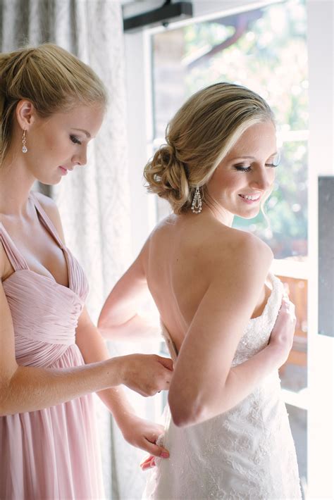 Bride Putting on Wedding Dress