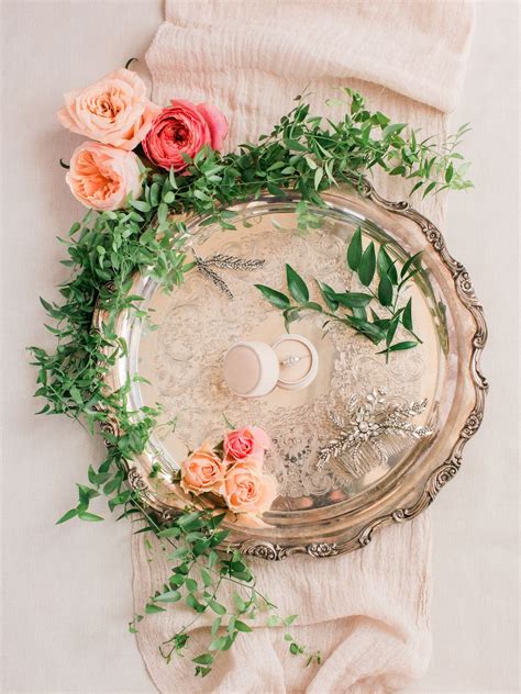 a tray with flowers and candles on top of it next to a white cloth ...