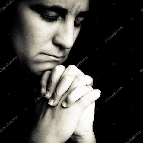 Woman praying isolated on black — Stock Photo © kmiragaya #11986670