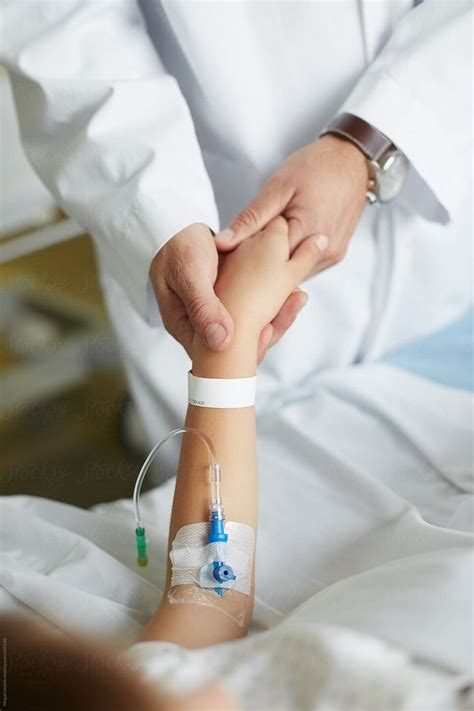 "Close Up Of Doctor Hands Holding The Hand Of A Child Patient" by Stocksy Contributor "Miquel ...