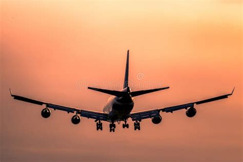 Airplane landing at sunset stock image. Image of modern - 104929041