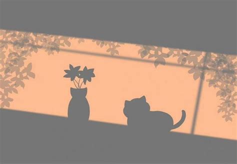 two cats are sitting on the window sill and one has a flower in it