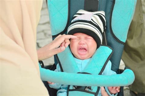 Hijab Mother Taking Care Her Crying Baby in the Park with Her Husband Stock Image - Image of ...