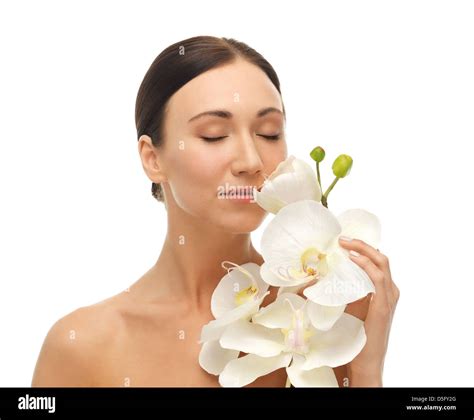 woman smelling white orchid flower Stock Photo - Alamy