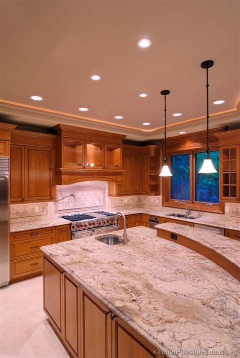 a large kitchen with marble counter tops and stainless steel appliances ...