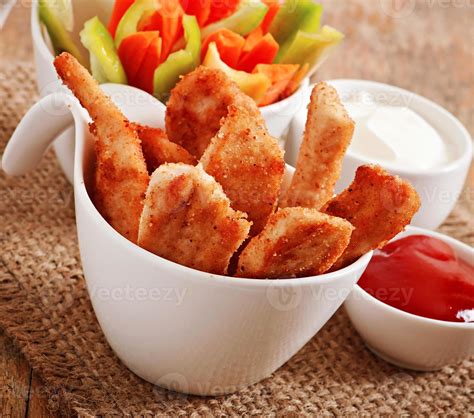 Chicken nuggets with sauce and vegetables 7253809 Stock Photo at Vecteezy