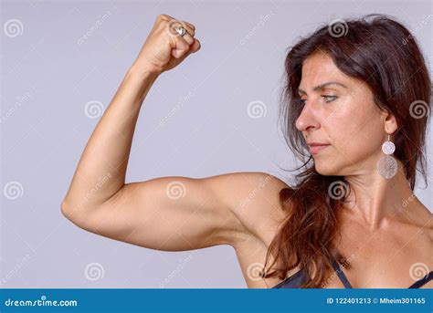 Strong Fit Mature Woman Flexing Her Arm Muscles Stock Image - Image of attractive, force: 122401213