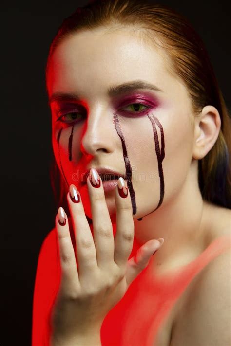 Scary Beauty Halloween Makeup Portrait of a Beautiful Red Hair Girl with Red Eye Shadows and ...