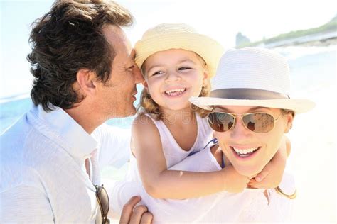 Happy Young Family Laughing Together on the Beach Stock Image - Image ...