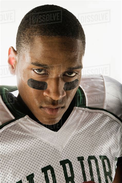 African football player with face paint under eyes - Stock Photo - Dissolve